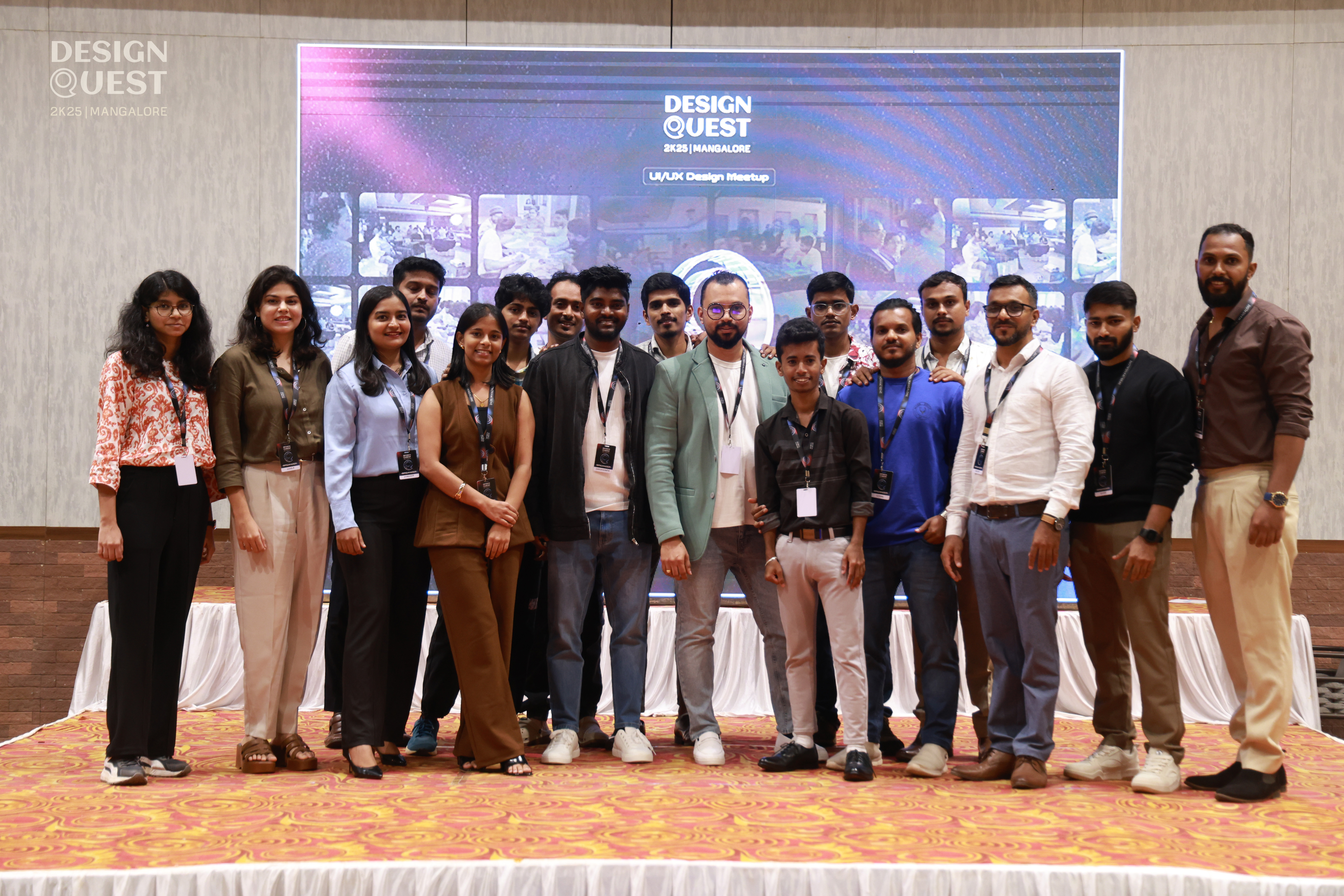 Organizing team and volunteers posing on stage at the Design Quest 2K25 UI/UX meetup in Mangalore.
